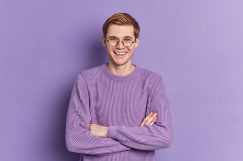 Man in purple sweater smiling